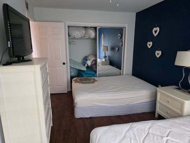 2124 Burton Dr Unit 116, Austin, TX 78741 - bedroom featuring dark wood-style flooring and a closet