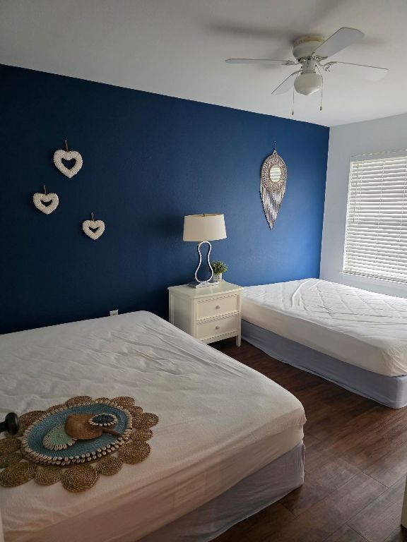 2124 Burton Dr Unit 116, Austin, TX 78741 - bedroom featuring wood finished floors and ceiling fan