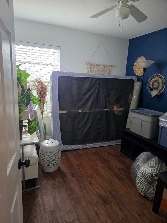 2124 Burton Dr Unit 116, Austin, TX 78741 - bedroom featuring wood finished floors and ceiling fan