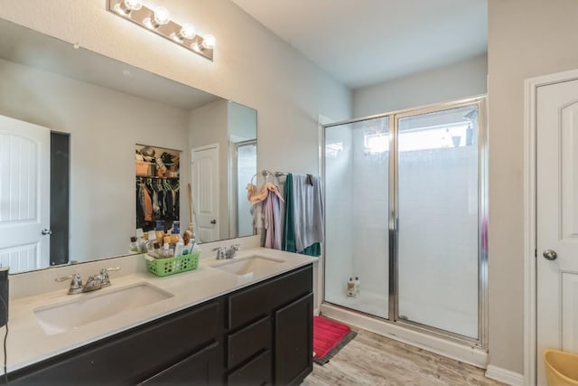 18430 Stevie Ray Dr, Round Rock, TX 78664 - full bath featuring a shower stall, double vanity, wood finished floors, and a spacious closet