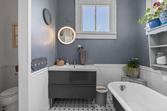 404 E 9th Ave, Belton, TX 76513 - bathroom with a wainscoted wall, a soaking tub, and vanity