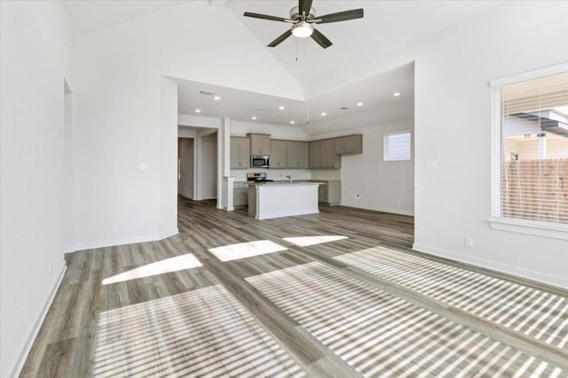 241 Snowbell St, San Marcos, TX 78666 - unfurnished living room featuring wood finished floors, a ceiling fan, high vaulted ceiling, and recessed lighting