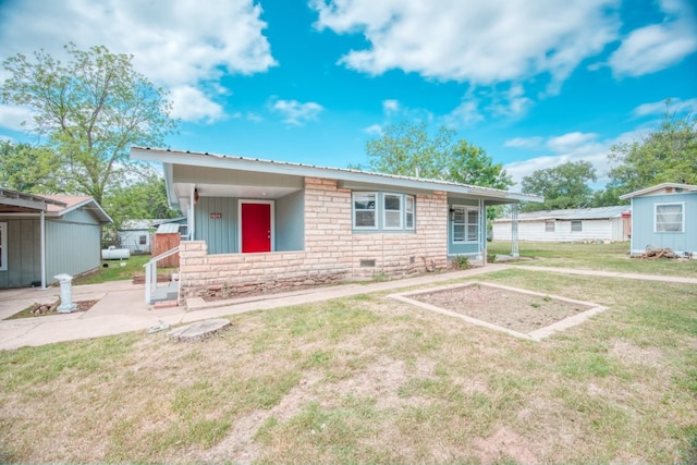 1030 Kingsriver Dr, Granite Shoals, TX 78654 - view of front of property with a front yard, stone siding, and a metal roof