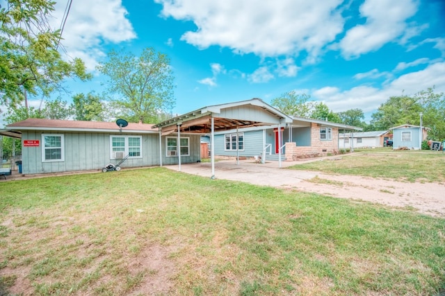 1030 Kingsriver Dr, Granite Shoals, TX 78654 - rear view of house featuring a yard, board and batten siding, driveway, and a patio area