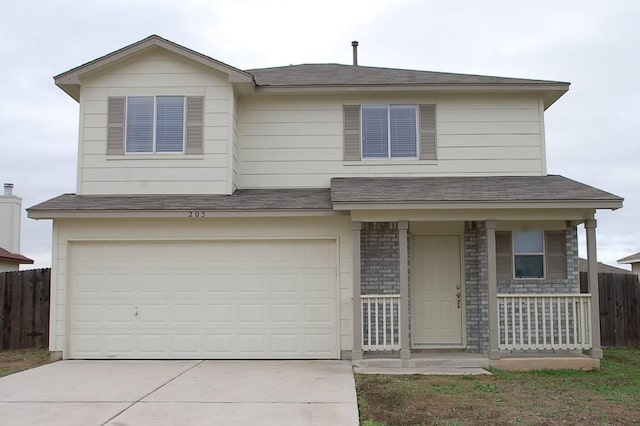 205 E Mitchell Dr, Hutto, TX 78634 - view of front facade featuring concrete driveway, an attached garage, and a porch