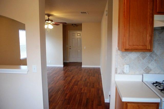 205 E Mitchell Dr, Hutto, TX 78634 - kitchen with ceiling fan, dark wood finished floors, tasteful backsplash, light countertops, and range