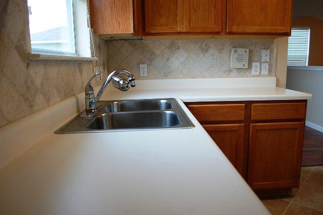 205 E Mitchell Dr, Hutto, TX 78634 - kitchen featuring healthy amount of natural light, backsplash, and light countertops