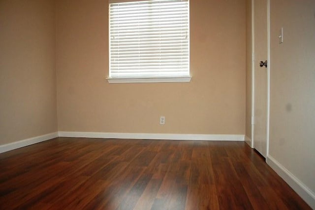 205 E Mitchell Dr, Hutto, TX 78634 - spare room featuring dark wood-style flooring and baseboards