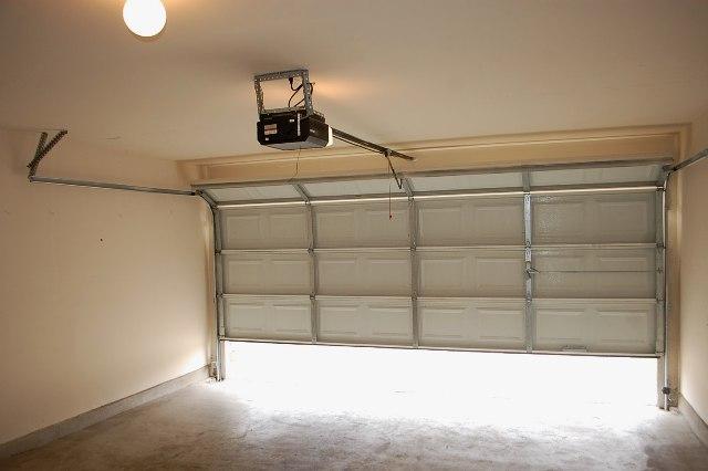 205 E Mitchell Dr, Hutto, TX 78634 - garage with a garage door opener and baseboards
