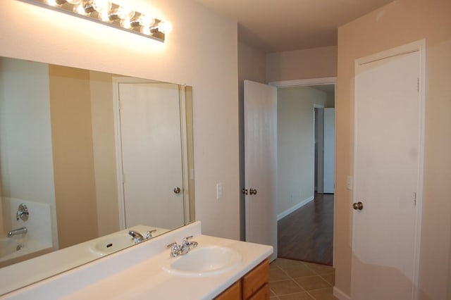 205 E Mitchell Dr, Hutto, TX 78634 - bathroom with vanity, a tub, and tile patterned floors