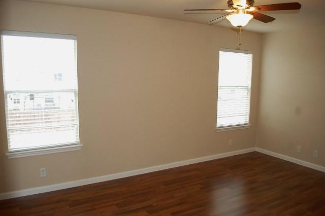 205 E Mitchell Dr, Hutto, TX 78634 - empty room featuring dark wood-type flooring and a ceiling fan