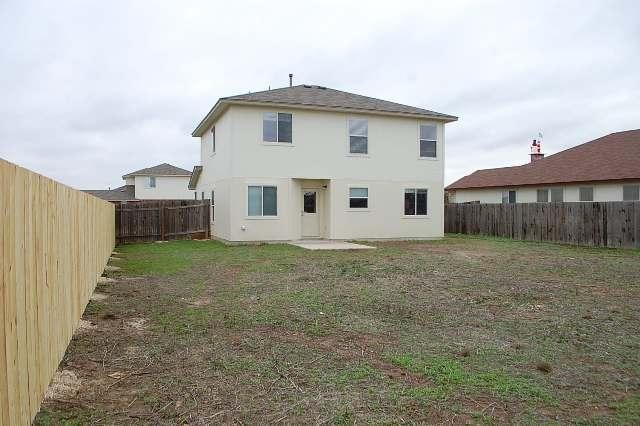 205 E Mitchell Dr, Hutto, TX 78634 - back of property with a fenced backyard and stucco siding