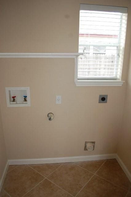 205 E Mitchell Dr, Hutto, TX 78634 - washroom featuring hookup for an electric dryer, tile patterned flooring, and washer hookup