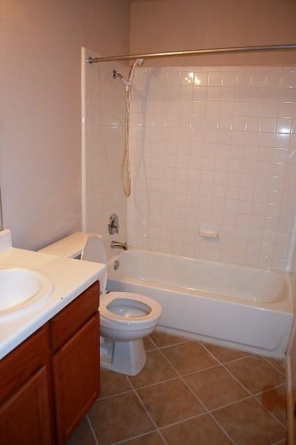 205 E Mitchell Dr, Hutto, TX 78634 - full bathroom featuring vanity, shower / washtub combination, and tile patterned floors