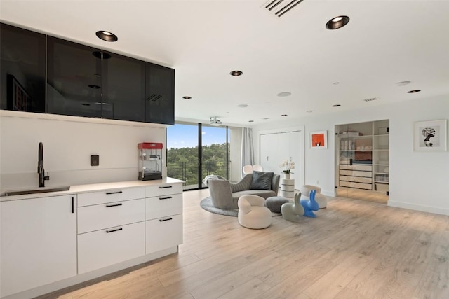 1501 Ridgecrest Dr, Austin, TX 78746 - living room with a wall of windows, light wood-style floors, and recessed lighting