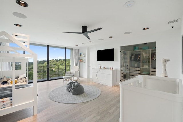 1501 Ridgecrest Dr, Austin, TX 78746 - living area featuring expansive windows, a ceiling fan, light wood-type flooring, and recessed lighting