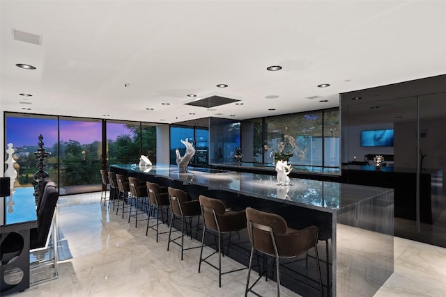 1501 Ridgecrest Dr, Austin, TX 78746 - bar area with a wall of windows, light marble finish floors, and recessed lighting