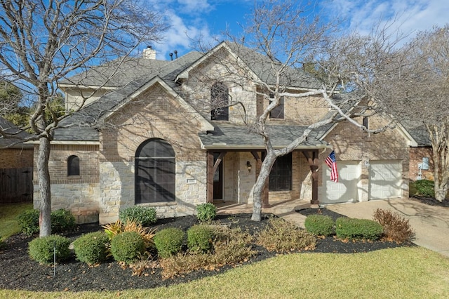 1116 Castle Path, Round Rock, TX 78681 - traditional-style house with a porch, stone siding, driveway, and brick siding