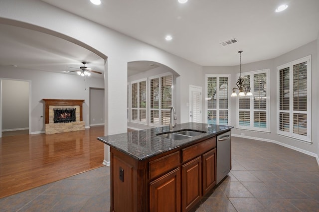 1116 Castle Path, Round Rock, TX 78681 - kitchen featuring dishwasher, a ceiling fan, recessed lighting, dark stone countertops, and a brick fireplace