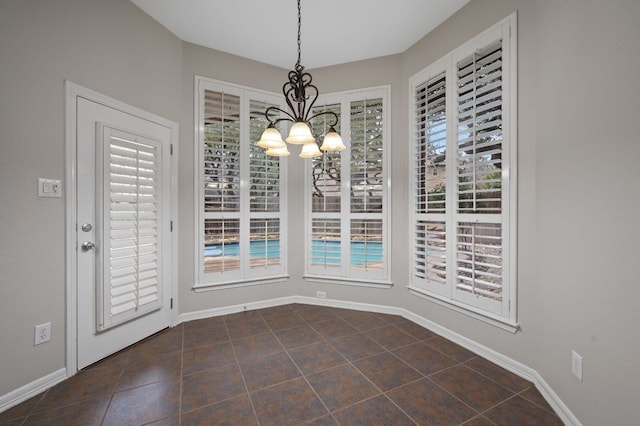 1116 Castle Path, Round Rock, TX 78681 - unfurnished dining area with a chandelier and dark tile patterned floors