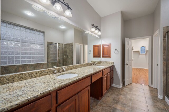 1116 Castle Path, Round Rock, TX 78681 - bathroom featuring a stall shower, double vanity, and tile patterned flooring