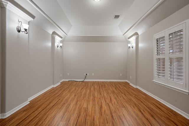 1116 Castle Path, Round Rock, TX 78681 - spare room with ornate columns, wood finished floors, and a tray ceiling