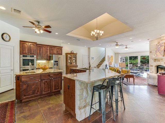 167 Manawianui Dr, Bastrop, TX 78602 - kitchen with a large island with sink, a ceiling fan, stainless steel appliances, open floor plan, and recessed lighting