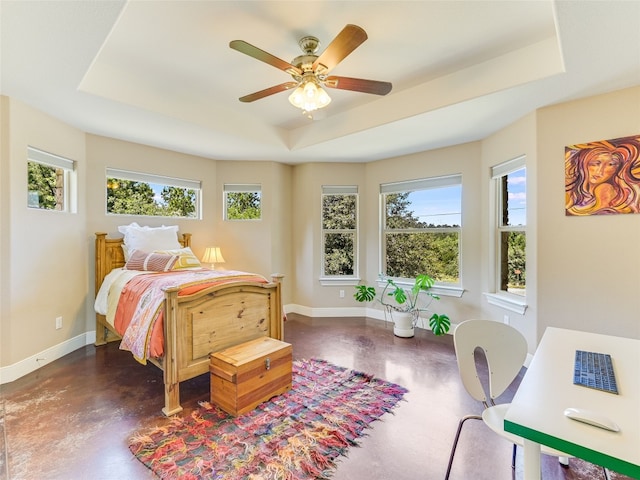 167 Manawianui Dr, Bastrop, TX 78602 - bedroom featuring a tray ceiling, finished concrete floors, and ceiling fan