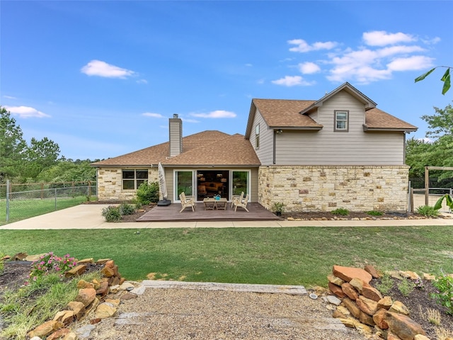 167 Manawianui Dr, Bastrop, TX 78602 - back of property with stone siding, a chimney, roof with shingles, and a wooden deck