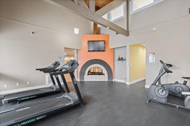 935 La Posada Dr Unit 148, Austin, TX 78752 - workout room with a high ceiling and a fireplace