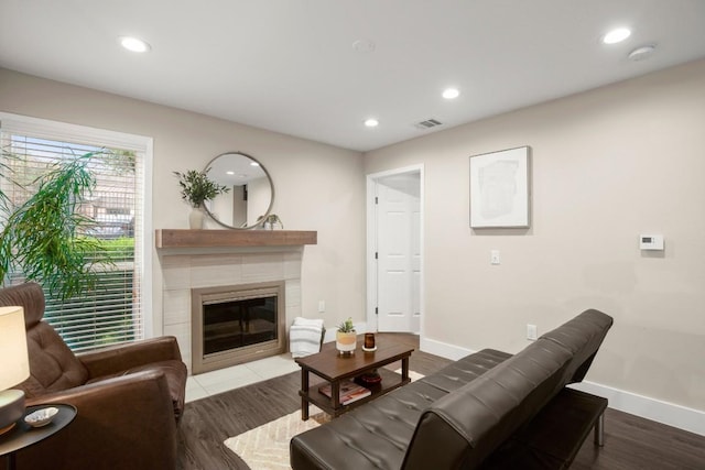 935 La Posada Dr Unit 148, Austin, TX 78752 - living area featuring a tiled fireplace, recessed lighting, and wood finished floors