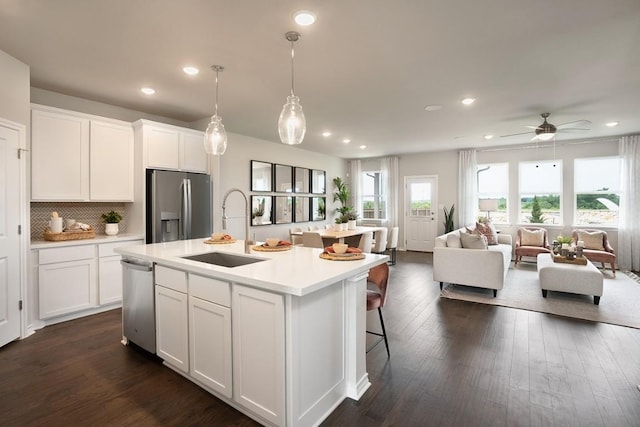 1425 Purple Martin Dr, Pflugerville, TX 78660 - kitchen with stainless steel appliances, recessed lighting, light countertops, white cabinetry, and an island with sink
