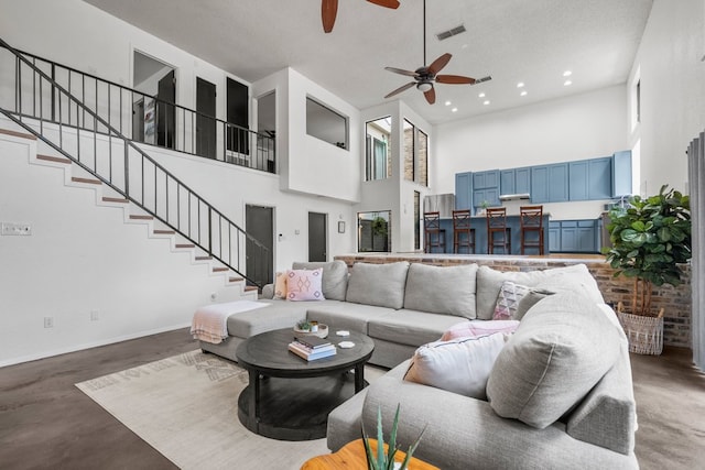 702 California Blvd Unit 702, New Braunfels, TX 78130 - living area featuring a towering ceiling, ceiling fan, stairway, and recessed lighting