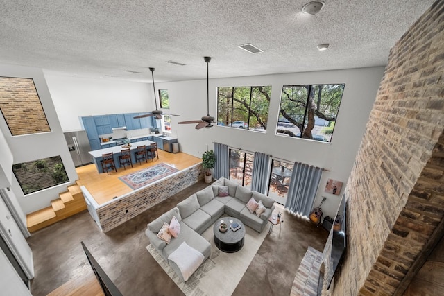702 California Blvd Unit 702, New Braunfels, TX 78130 - living area featuring a ceiling fan and a textured ceiling