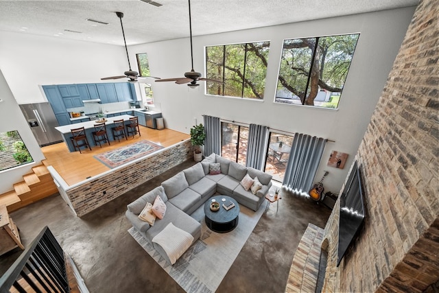 702 California Blvd Unit 702, New Braunfels, TX 78130 - living room with concrete flooring, a high ceiling, a textured ceiling, and ceiling fan