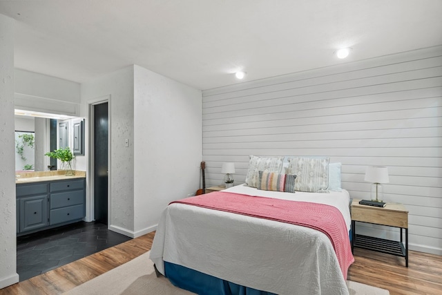 702 California Blvd Unit 702, New Braunfels, TX 78130 - bedroom with wood finished floors, wooden walls, connected bathroom, and recessed lighting