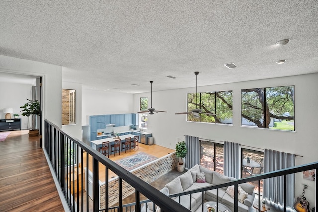 702 California Blvd Unit 702, New Braunfels, TX 78130 - corridor featuring a textured ceiling and wood finished floors