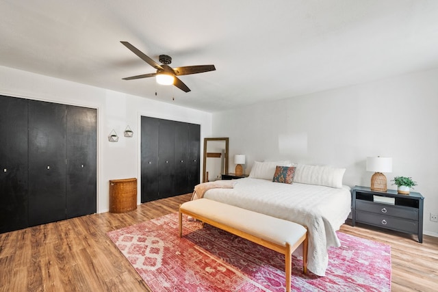702 California Blvd Unit 702, New Braunfels, TX 78130 - bedroom featuring light wood-style flooring, two closets, and ceiling fan