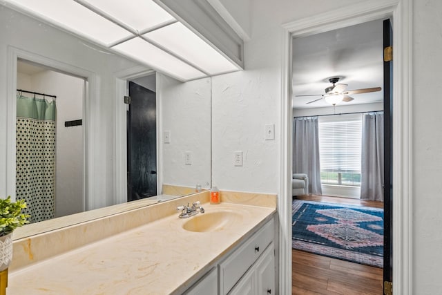 702 California Blvd Unit 702, New Braunfels, TX 78130 - bathroom featuring wood finished floors, vanity, ceiling fan, and a textured wall