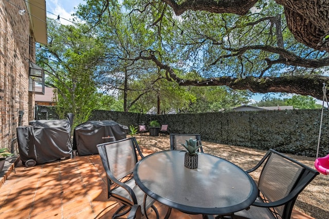 702 California Blvd Unit 702, New Braunfels, TX 78130 - deck featuring a fenced backyard, grilling area, and outdoor dining area
