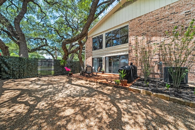 702 California Blvd Unit 702, New Braunfels, TX 78130 - back of house with a fenced backyard, brick siding, and a patio area