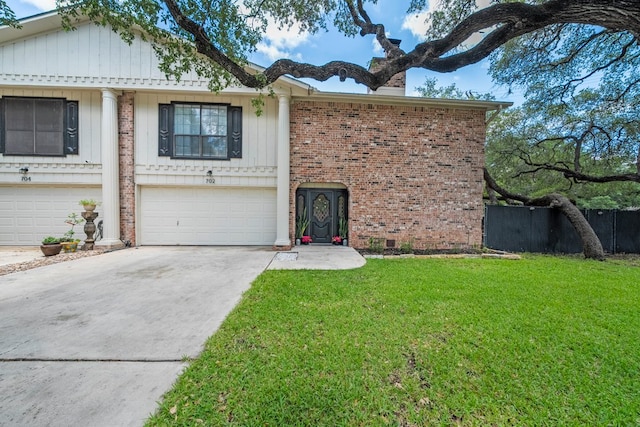702 California Blvd Unit 702, New Braunfels, TX 78130 - view of front of home featuring driveway, a front lawn, a garage, a chimney, and brick siding