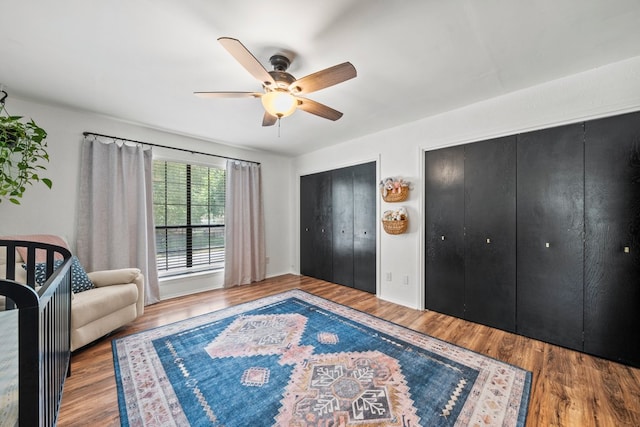 702 California Blvd Unit 702, New Braunfels, TX 78130 - bedroom featuring two closets, wood finished floors, and ceiling fan