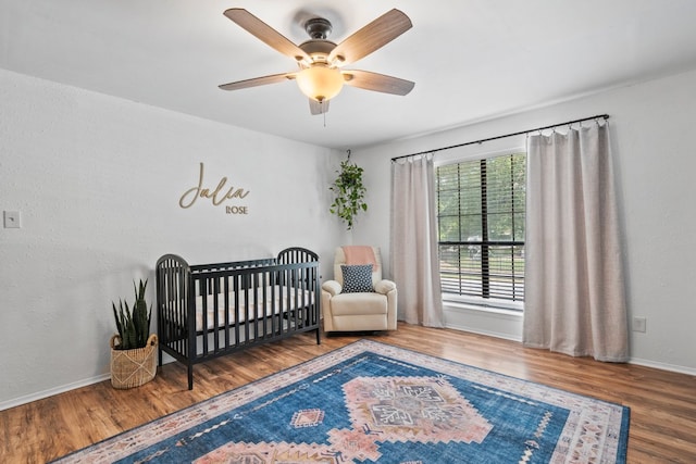 702 California Blvd Unit 702, New Braunfels, TX 78130 - bedroom featuring wood finished floors, a nursery area, and a ceiling fan