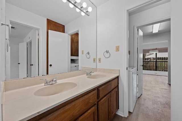 3801 Menchaca Rd Unit 6, Austin, TX 78704 - bathroom with independent washer and dryer, double vanity, and wood finished floors