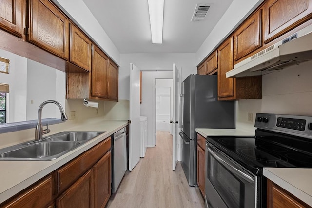 3801 Menchaca Rd Unit 6, Austin, TX 78704 - kitchen featuring appliances with stainless steel finishes, under cabinet range hood, light wood-style floors, and light countertops