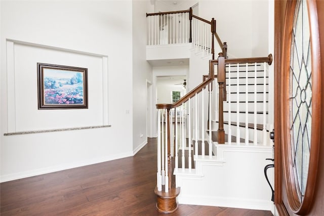 9527 Indigo Brush Dr, Austin, TX 78726 - entrance foyer with wood finished floors, stairway, a ceiling fan, and a towering ceiling