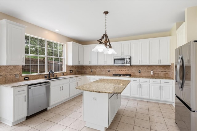 9527 Indigo Brush Dr, Austin, TX 78726 - kitchen featuring stainless steel appliances, decorative backsplash, a kitchen island, and white cabinetry