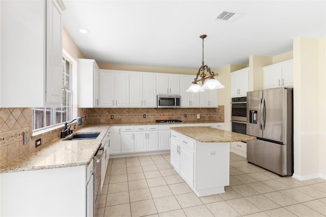 9527 Indigo Brush Dr, Austin, TX 78726 - kitchen featuring stainless steel appliances, decorative backsplash, and white cabinetry