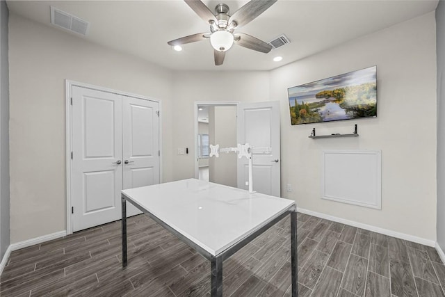 7808 Glover Dr, Austin, TX 78744 - home office featuring dark wood-type flooring, ceiling fan, and recessed lighting